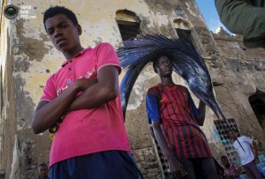 A Somali man pauses while carrying a large sailfish on his head as he transports it to Mogadishu's fish market in the Xamar Weyne district of the Somali capital